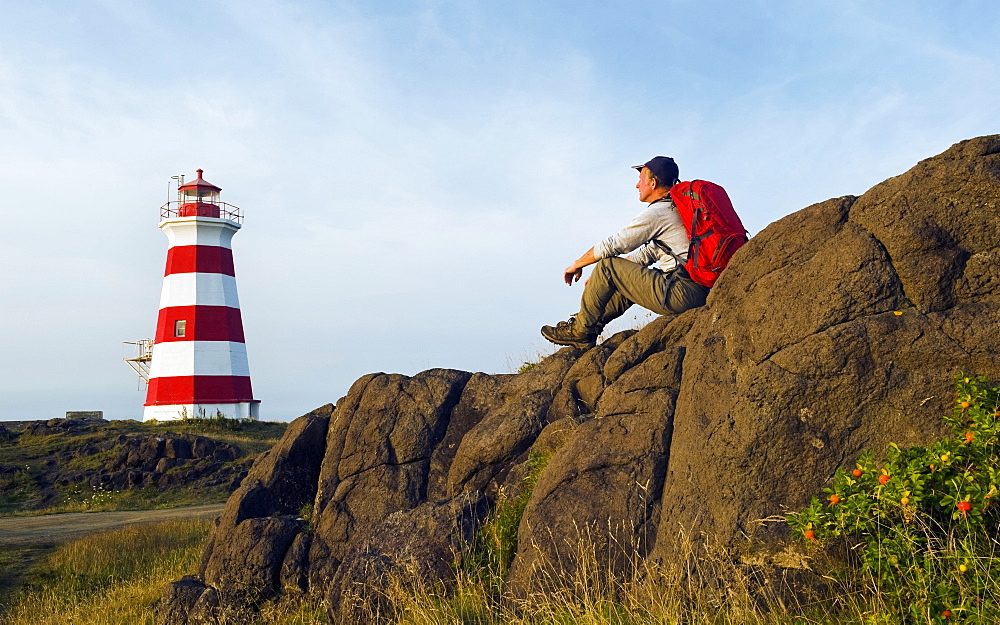 Hiker Looking Out Over Brier Island Lighthouse, Brier Island, Bay Of Fundy, Nova Scotia, Canada