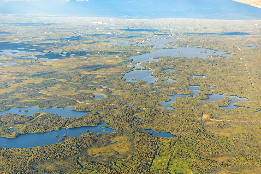 Aerial View Of A Road Passing Through Low Lying Land With Lakes And Ponds, South-Central Alaska, Alaska, United States Of America