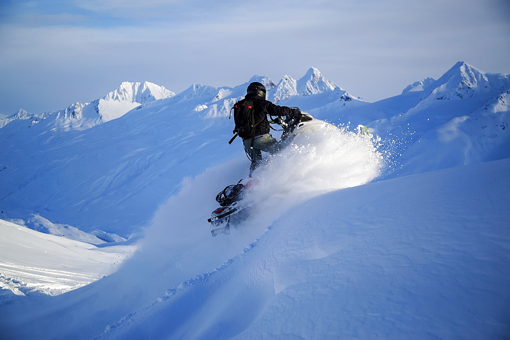 Man Snowmobiling In Thompson Pass Near Valdez, Southcentral Alaska, Winter