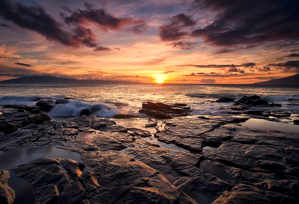 Sunset Over The Ocean With Wet Black Rock Along The Shore, Hawaii, United States Of America