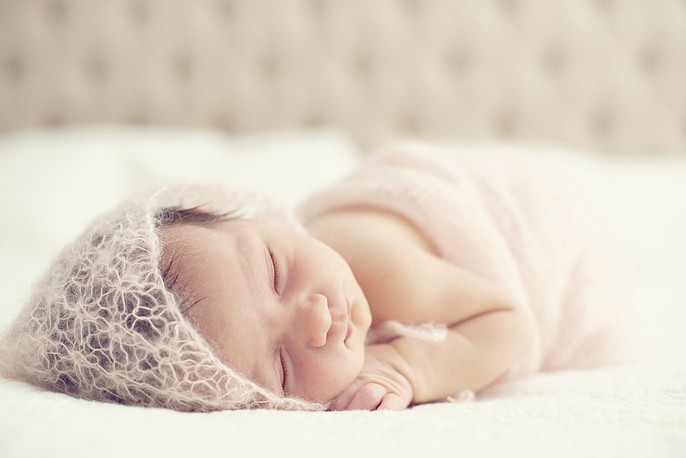 Portrait Of A Newborn Baby Laying On A Bed With White Comforter, Toronto, Ontario, Canada