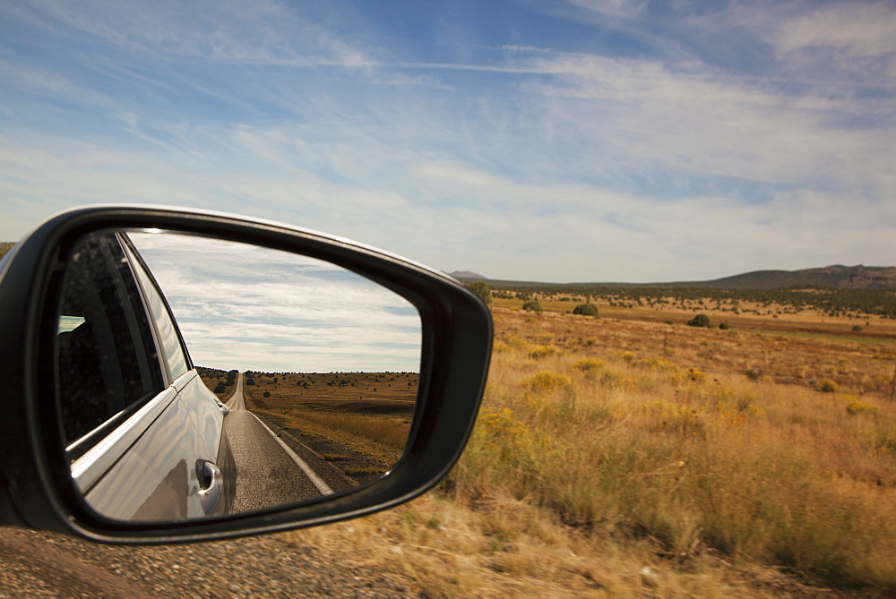 Driving Route 66 With Landscape Reflected In Car Mirror, Arizona, United States Of America