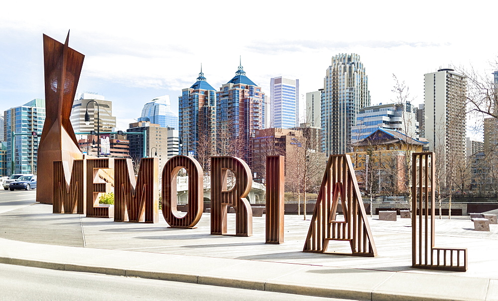 A sign spelled in lettering for Memorial Drive with the Calgary skyline in the background, Calgary, Alberta, Canada