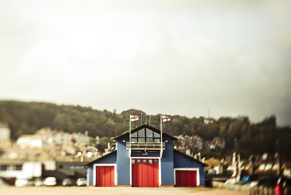 A boat house with three red doors at the waterfront, London, England