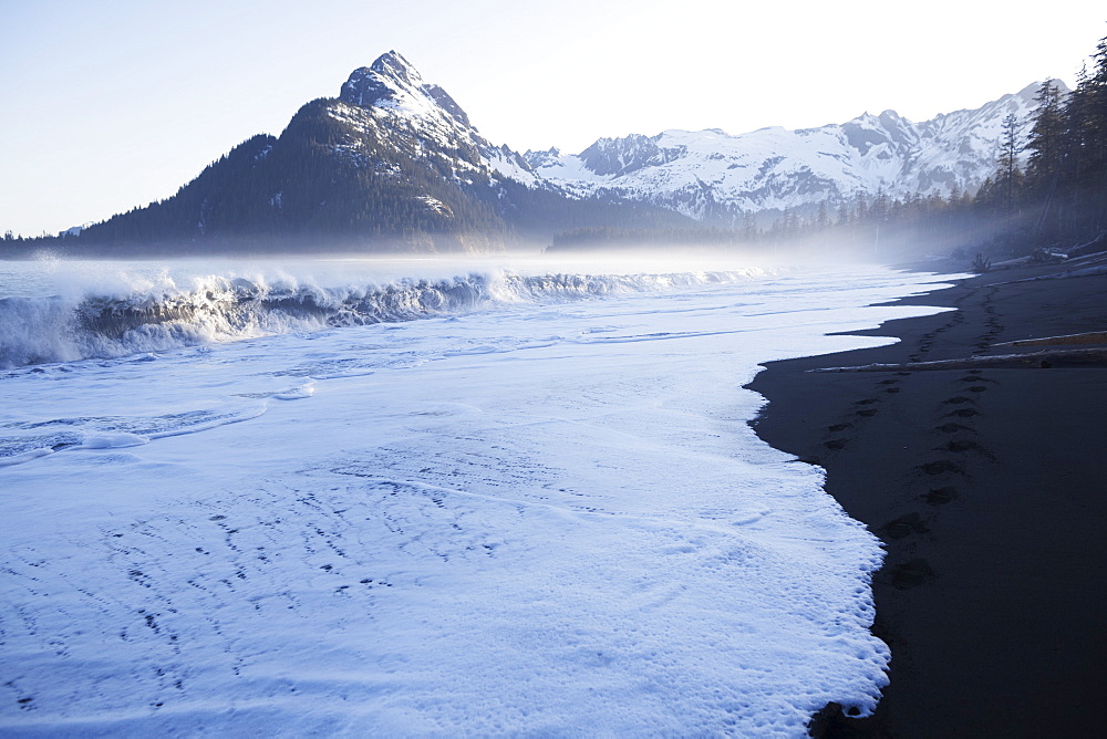 Waves Crashing Onto The Beach Along The Coast Along The Kenai Mountains, Kachemak Bay State Park, Alaska, United States Of America