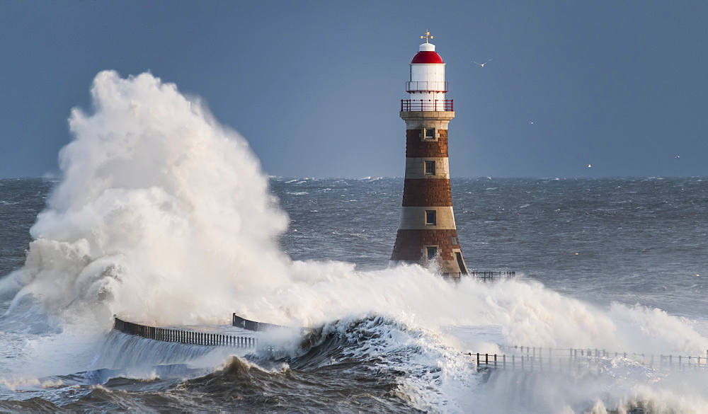 Waves Splashing Against Roker Lighthouse At The End Of A Pier, Sunderland, Tyne And Wear, England