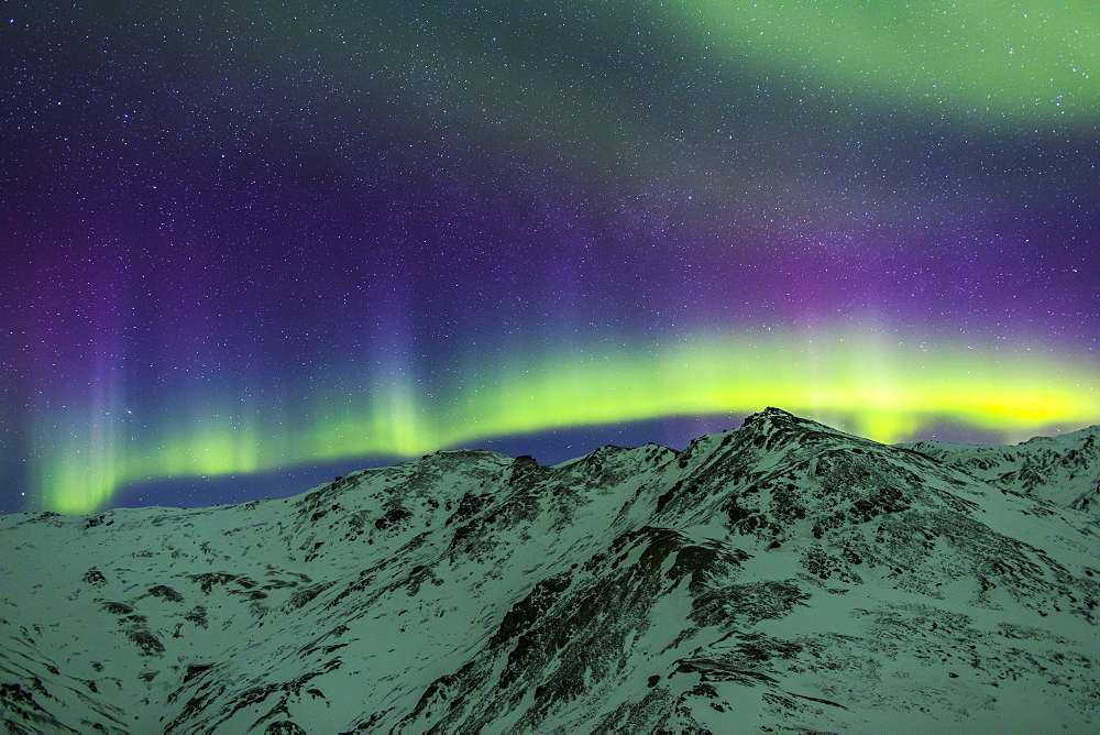 Aurora Borealis Over Mountains Within Denali National Park On A Very Cold Winter Night. The Andromeda Galaxy Is Visible To The Left, Alaska, United States Of America