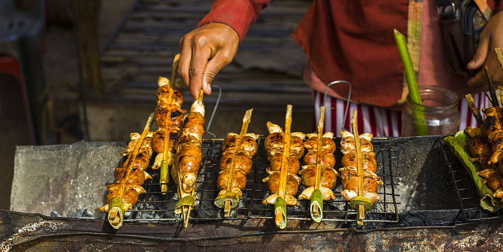 A Hand Turns Skewers On A Grill, Preah Dak, Siem Reap Province, Cambodia