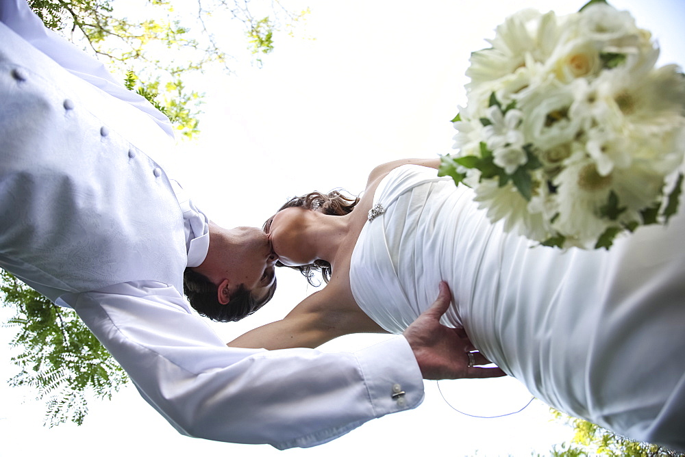 Low Angle View Of A Bride And Groom Kissing On The Wedding Day, Ontario, Canada