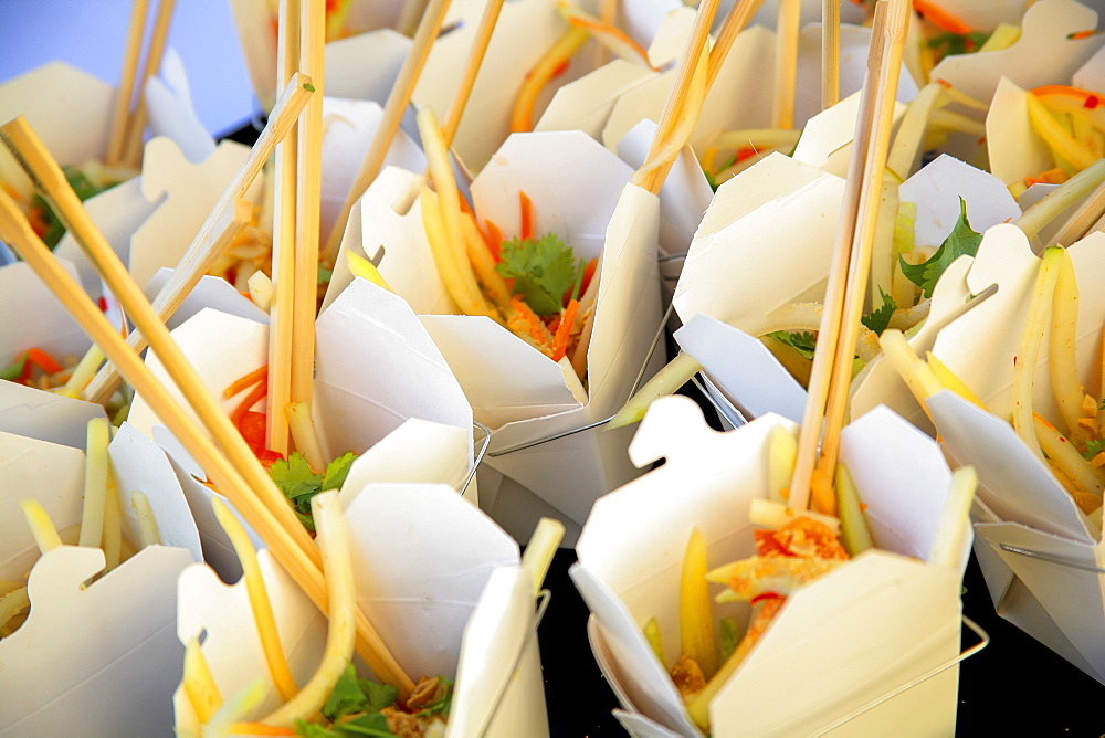 Bento Boxes Filled With Food And Chopsticks