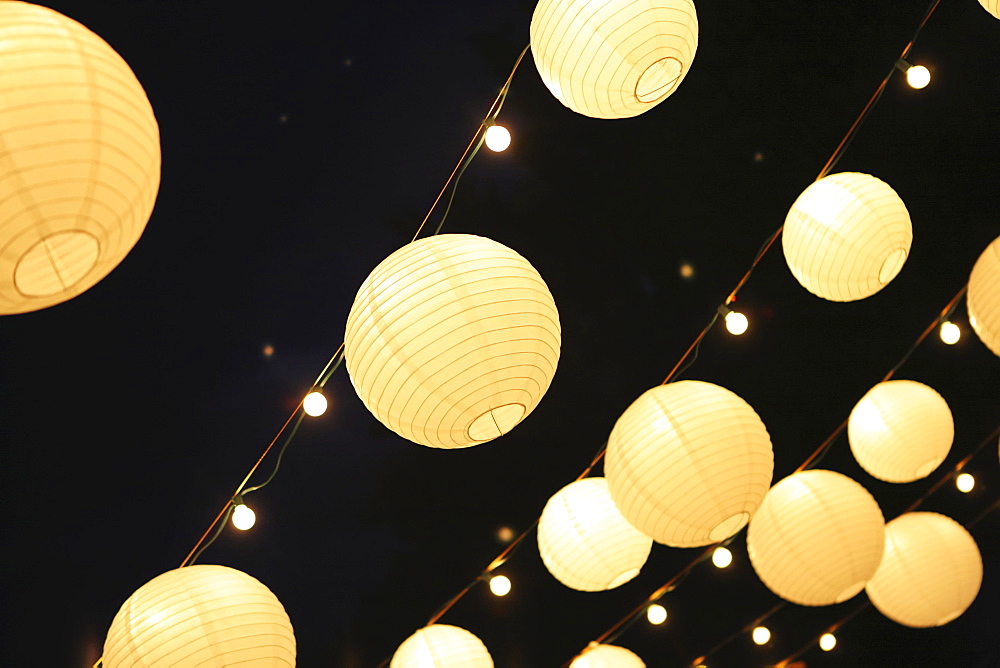 Illuminated Round Lanterns Strung In Rows