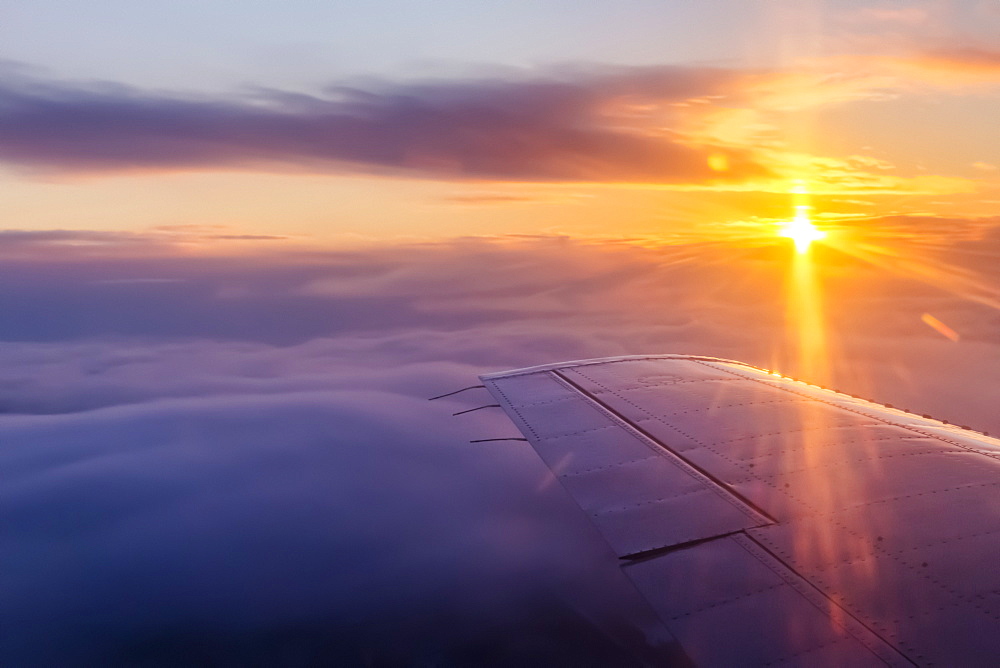 Aerial View Of A Cloudy Sunrise In Winter From The Passenger Seat Of A Commercial Airplane, Interior Alaska, Fairbanks, Alaska, United States Of America