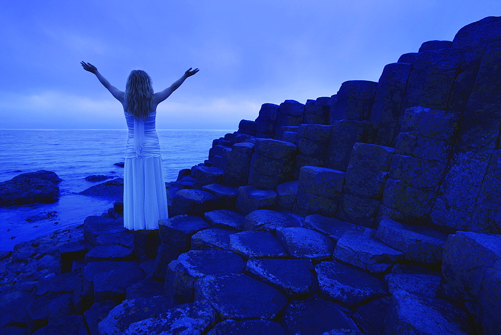 Woman Worshipping By The Sea