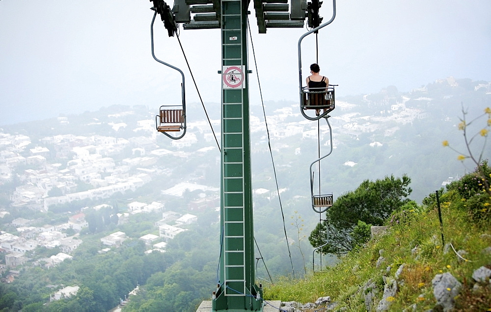 Capri, Italy; Woman Riding Chairlift To The Top Of Monte Solaro