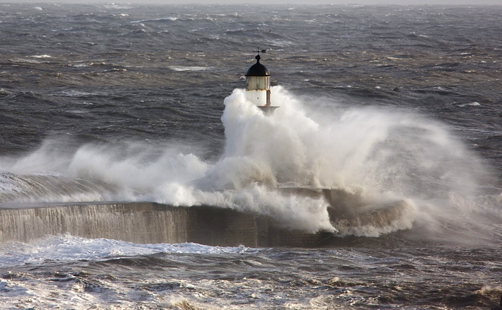 Seaham, Teesside, England; Waves Crashing On A Lighthouse In The Ocean