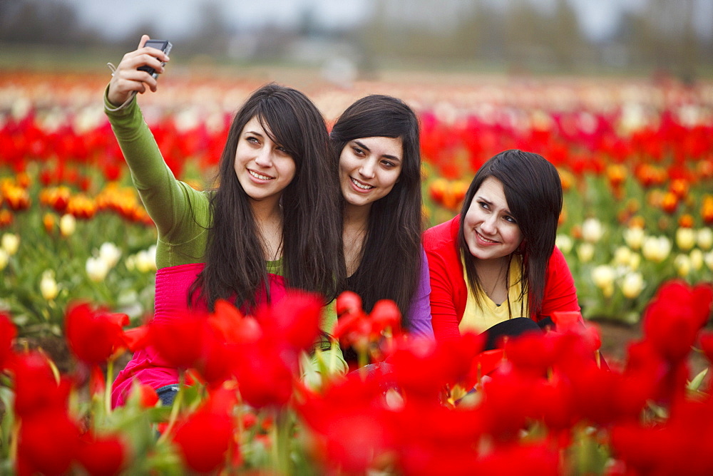 Woodburn, Oregon, United States Of America; Teenage Girls Playing In The Tulip Fields Of Wooden Shoe Tulip Farm