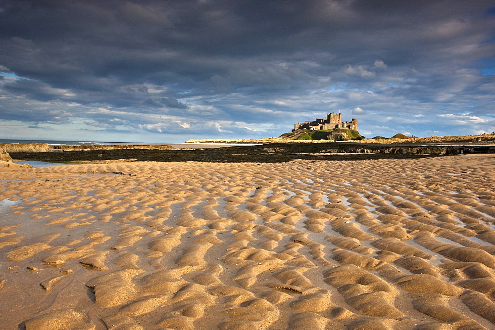 Bamburgh, Northumberland, England; View Of Bamburgh Castle From A Sandy Beach