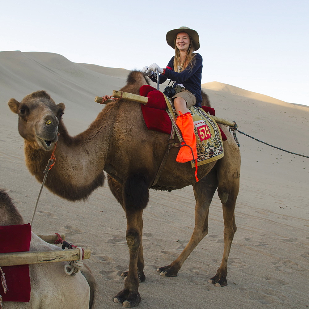 A girl riding a camel, Jiuquan gansu china