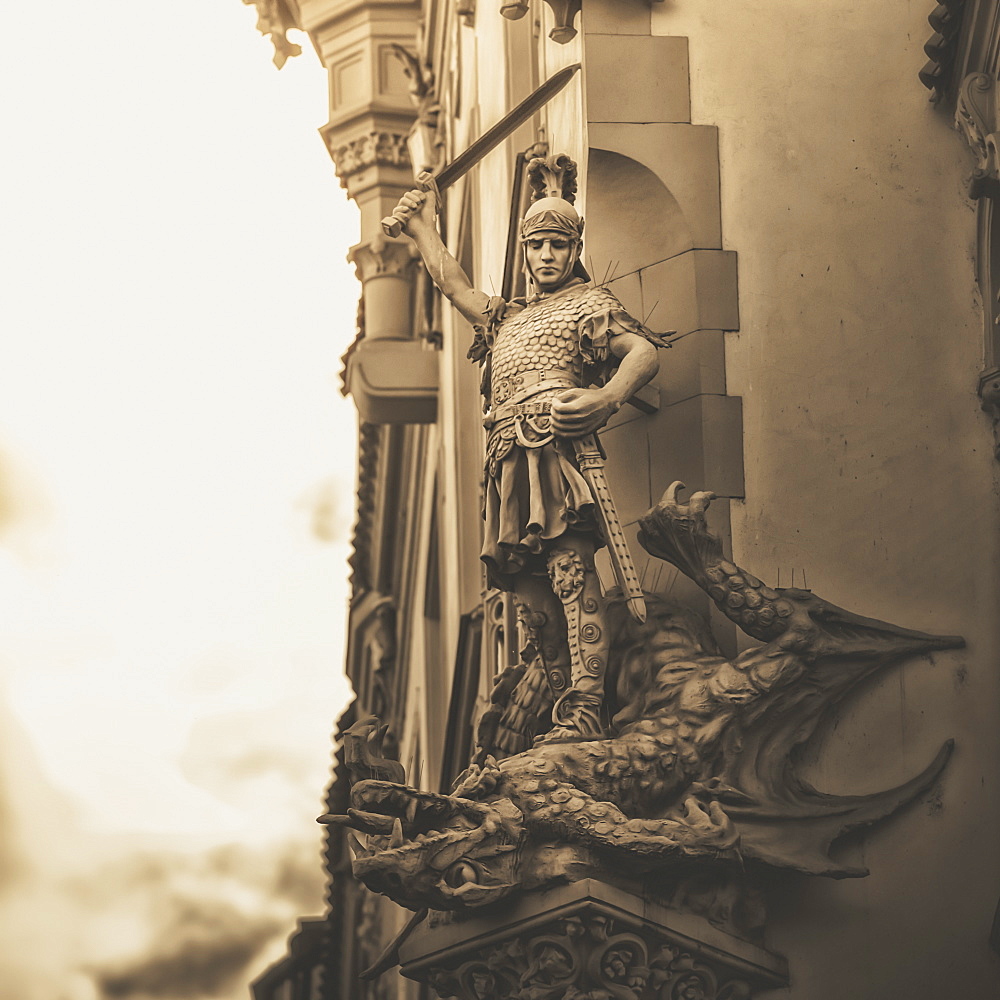 Statue On The Side Of A Building Of A Warrior Slaying A Dragon, Prague, Czech Republic