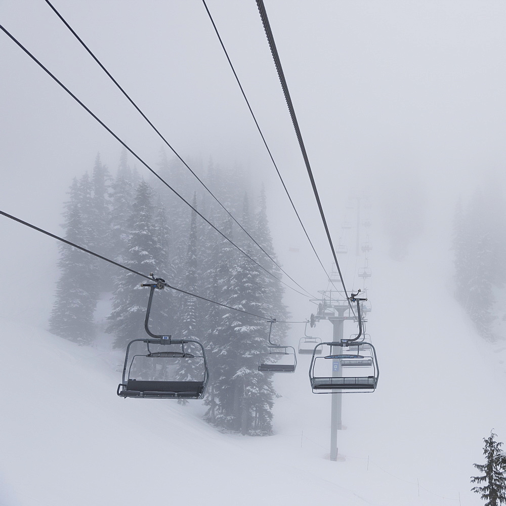 Empty Chairlift At A Ski Resort In Fog, Whistler, British Columbia, Canada