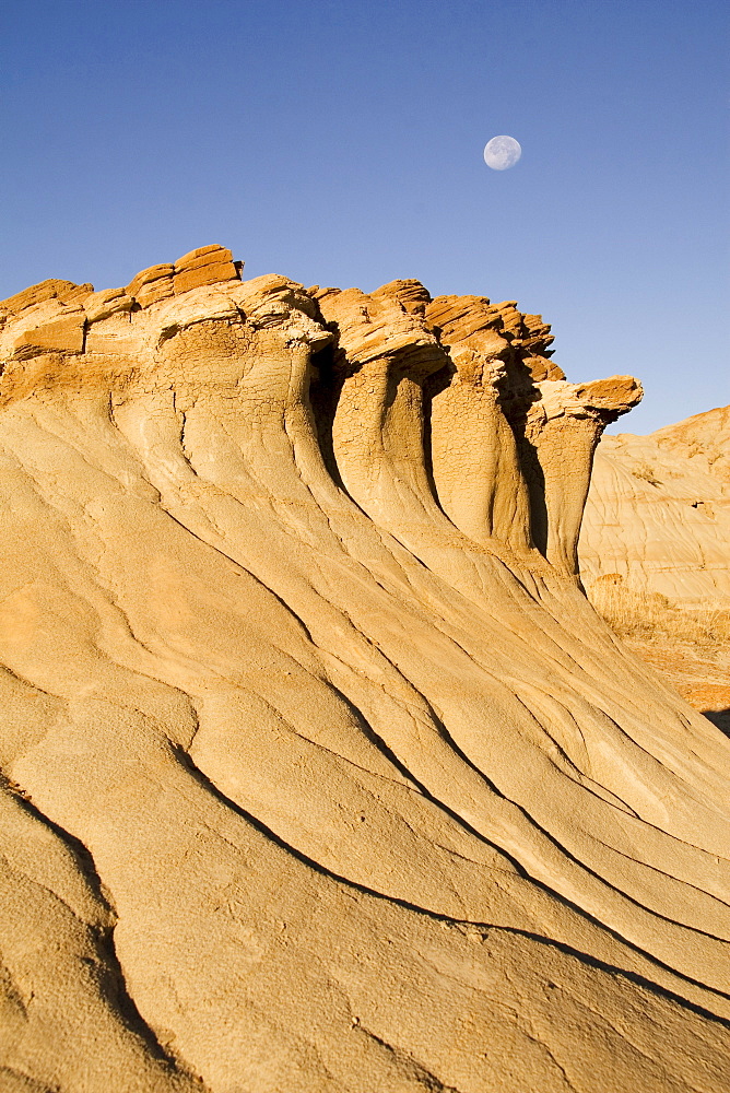 Hoodoos And Moon With Blue Sky In Alberta, Canada