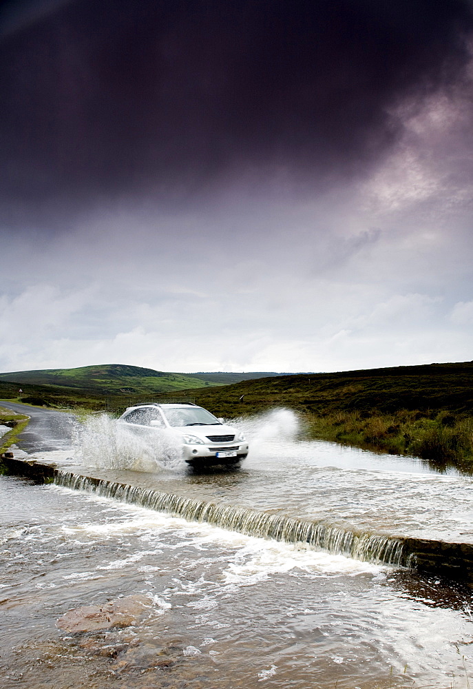 Car Driving Down Flooded Road, Yorkshire, England