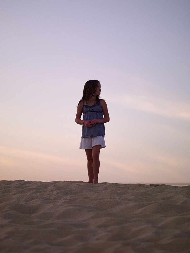 Girl Standing On The Beach