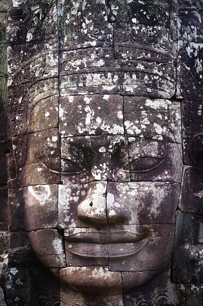 A face sculpture on a stone wall at angkor wat, Cambodia