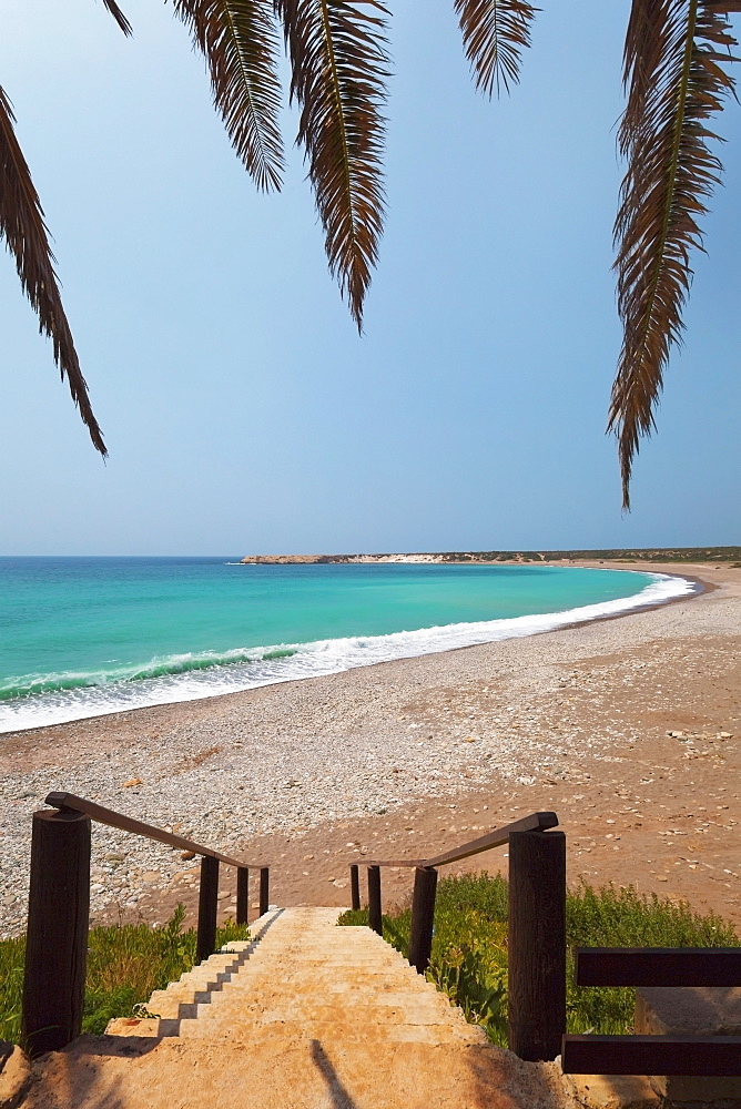 Steps leading down to the beach and turquoise ocean water, Akamas peninsula, cyprus