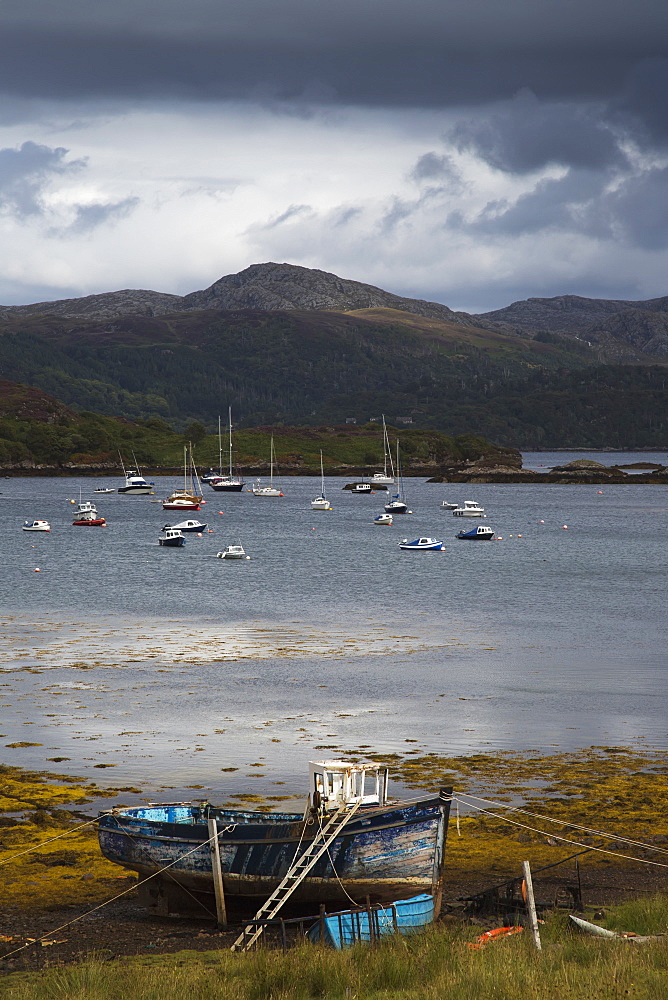 Boats mooring in the harbour under storm clouds, Kenmore wester ross scotland