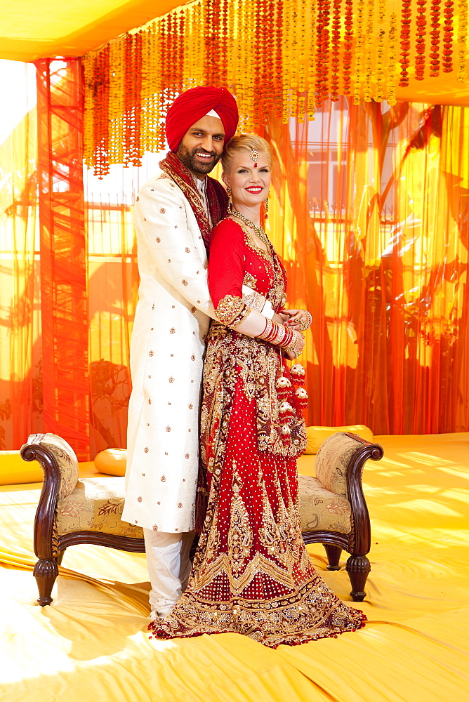 Portrait Of A Mixed Race Couple On Their Wedding Day In Traditional Indian Garments For A Wedding, Ludhiana, Punjab, India