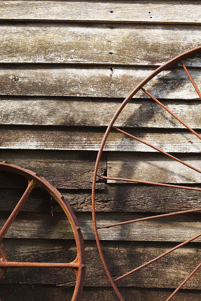 Old Wagon Wheels Against A Wooden Wall, Margaret River, West Australia, Australia