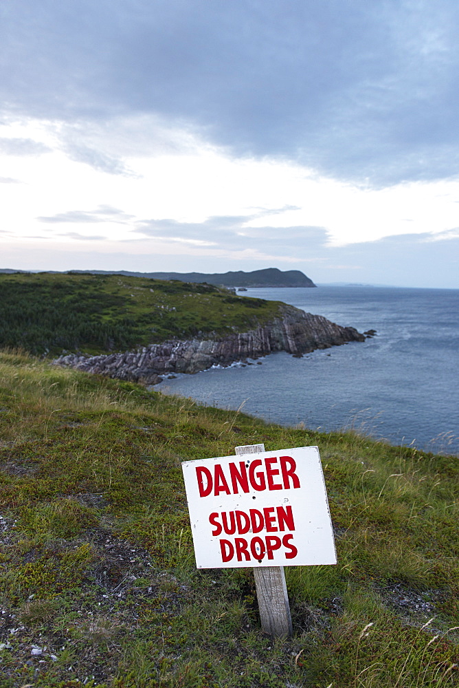 A Sign Warning A Danger And Sudden Drops Along The Atlantic Coastline, Calvert, Newfoundland And Labrador, Canada