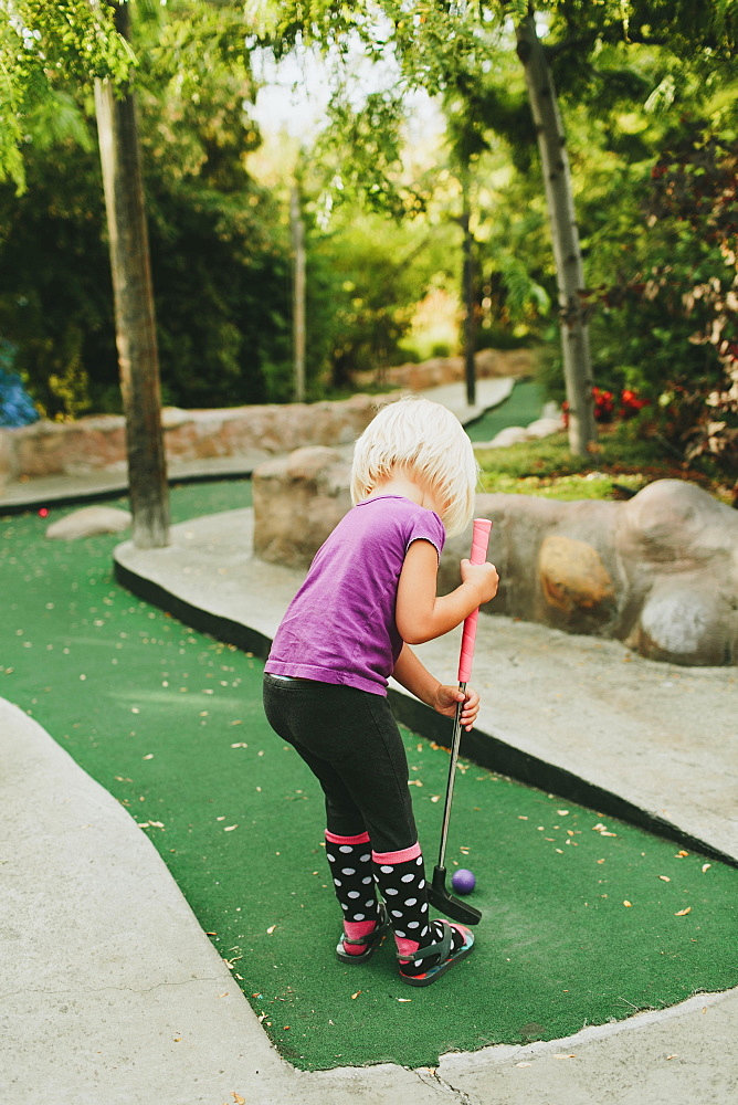 A Young Girl Playing Miniature Golf, Peachland, British Columbia, Canada