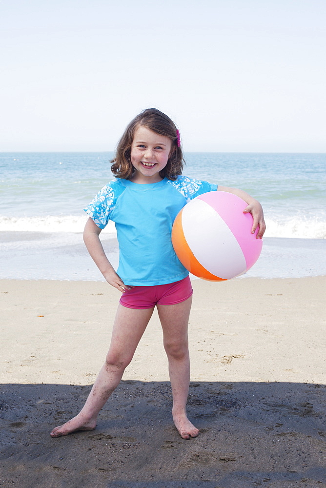 Young Girl With A Beach Ball On The Beach, San Francisco, California, United States Of America