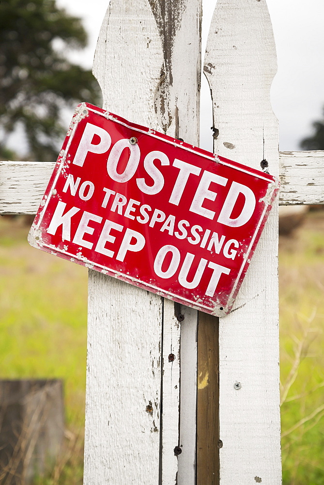 Sign On An Old White Picket Fence Saying Posted Keep Out No Trespassing, Monterey Bay, California, United States Of America