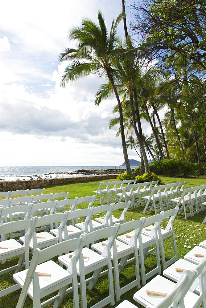 Chairs Set Up For An Outdoor Wedding At The Water's Edge With A View Of The Ocean, Honolulu, Oahu, Hawaii, United States Of America