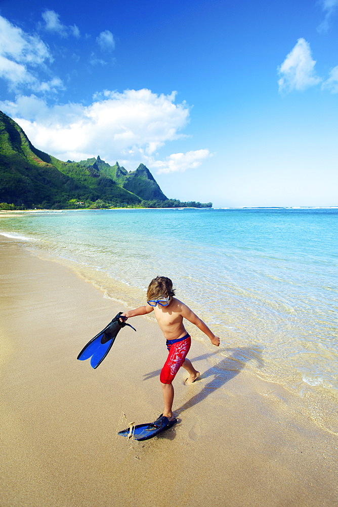 A Boy On The Beach With Snorkelling Gear, Kauai, Hawaii, United States Of America