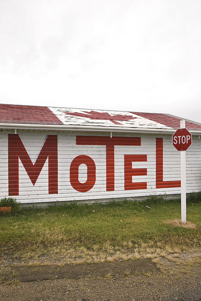 A Motel With The Sign Written In Large Letters On The Side Of The Building And A Canadian Flag On The Roof, Broadview, Saskatchewan, Canada