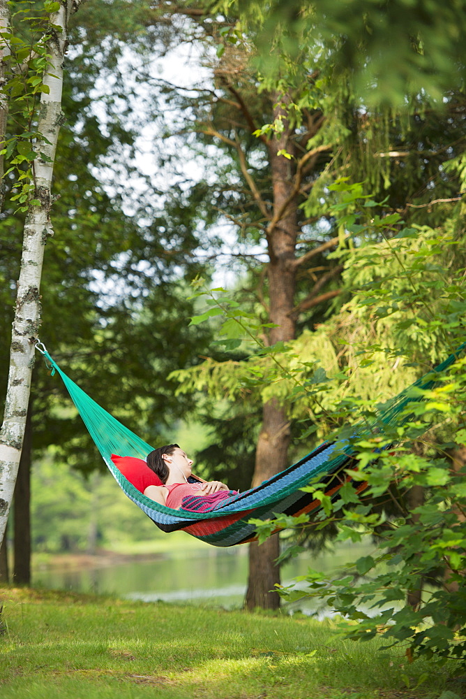 Girl Sleeping In Hammock With Headphones, Ontario, Canada