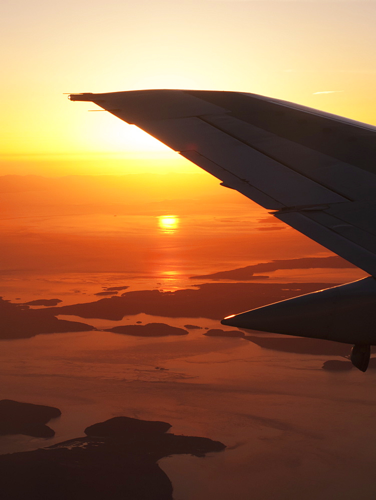 Silhouette Of Airplane Tail In Flight At Sunset, British Columbia, Canada