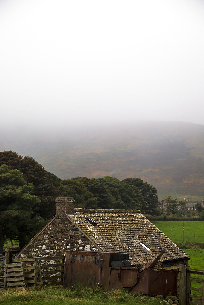 Dense Fog Over The Hills With A Small Stone House In The Foreground, Northumberland, England