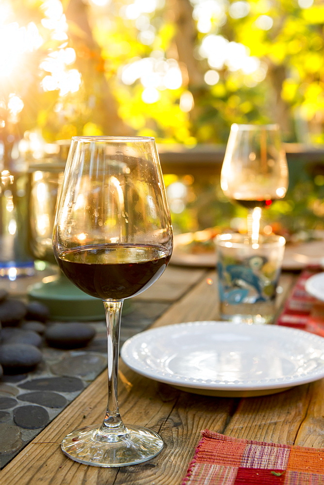 Glasses Of Red Wine On A Table Set For A Meal, Ontario, Canada