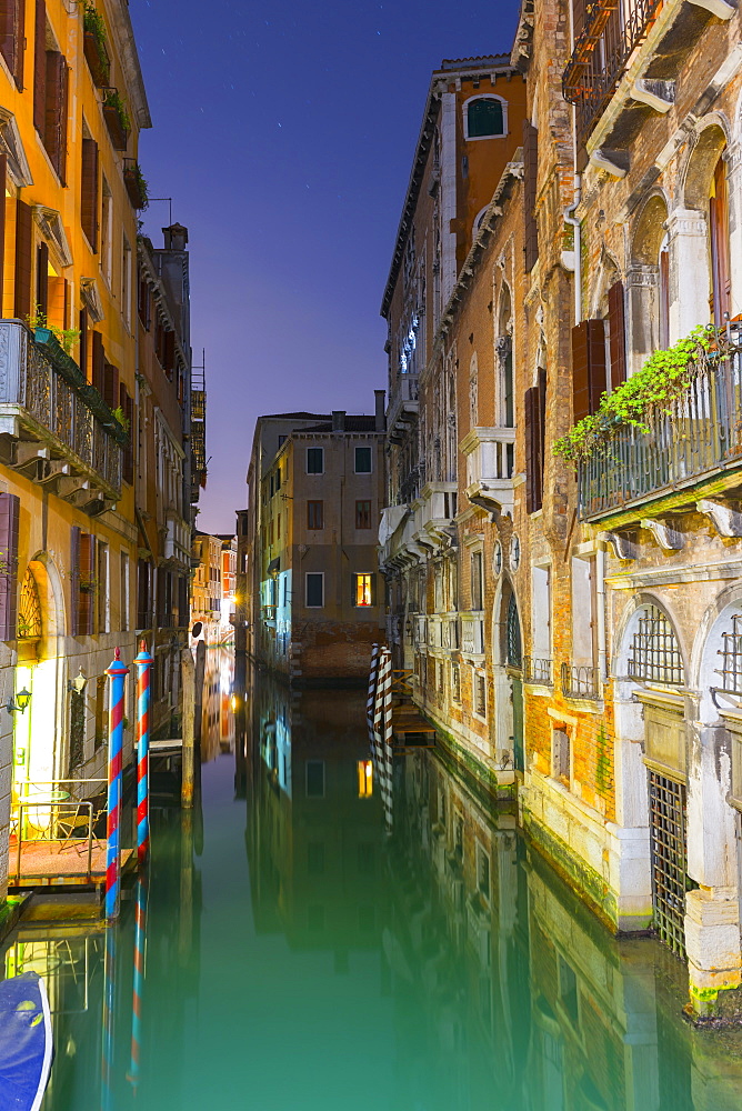 Turquoise Water In A Narrow Canal Between Buildings At Dusk, Venice, Veneto, Italy