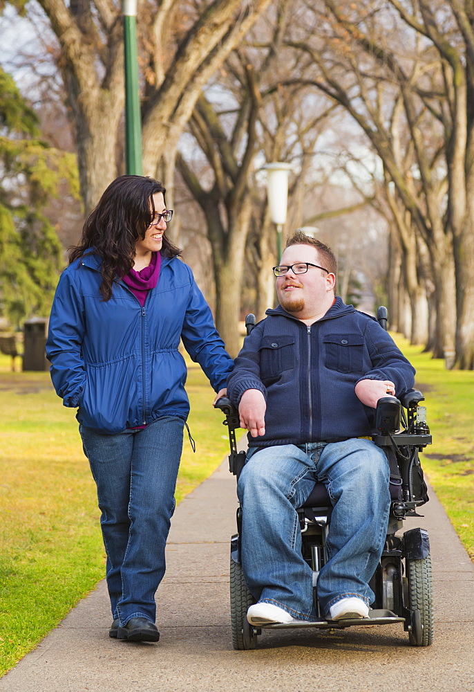 Disabled Husband Talking With His Wife While Walking In A Park In Autumn, Edmonton, Alberta, Canada