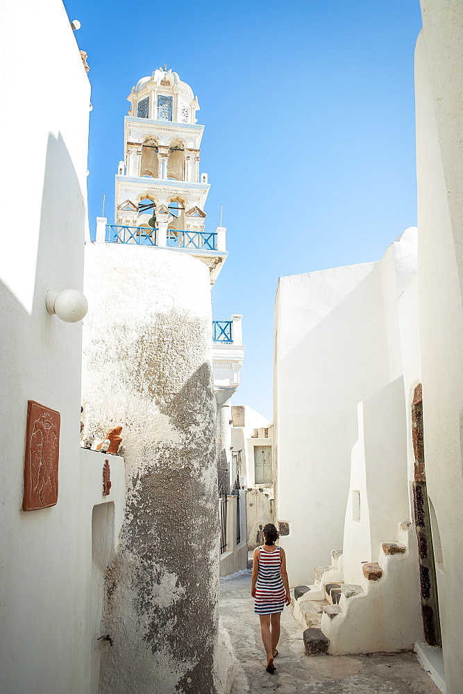 A Woman Walks Between Whitewash Buildings, Megalochori, Santorini, Greece