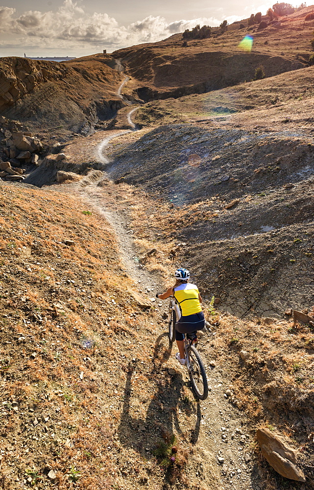 Woman Riding A Mountain Bike On A Rugged Trail, Tarifa, Cadiz, Andalusia, Spain