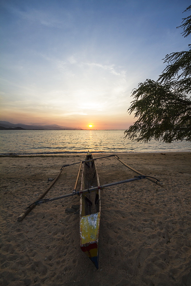 Outrigger Boat On An Areia Branca Beach At Sunset, Dili, East Timor