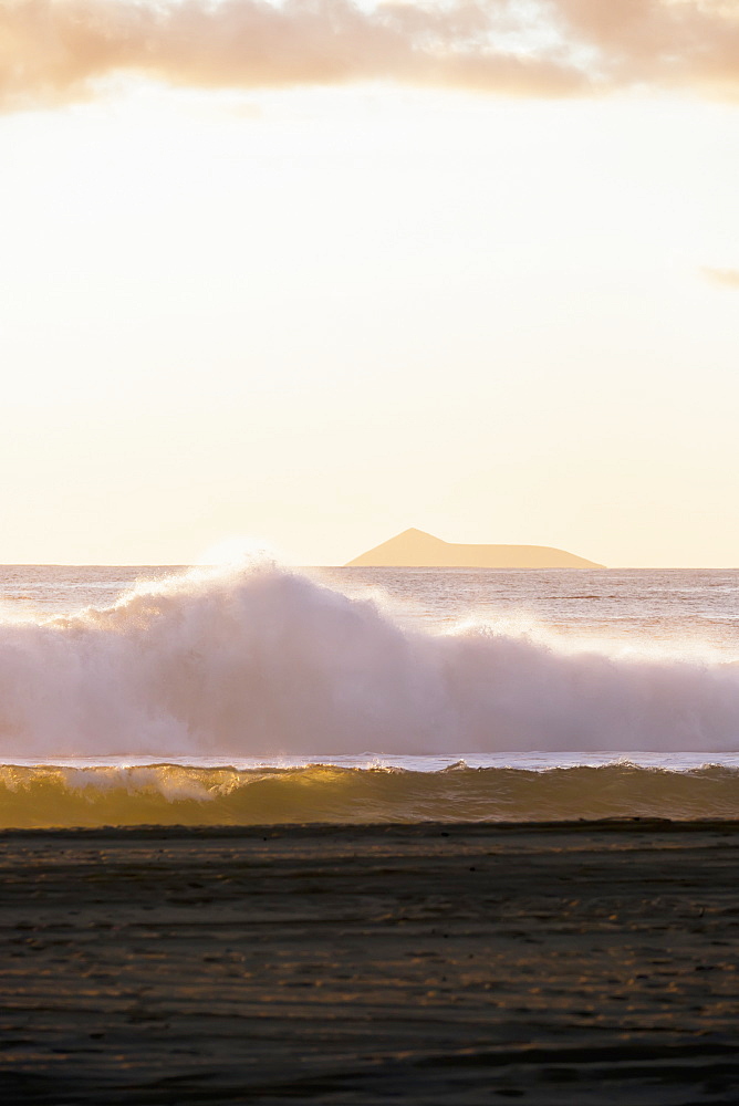 Golden Surf Visible From Barking Sands Beach In Kekaha With Lehua Visible In The Distance, Kekaha, Kauai, Hawaii, United States Of America