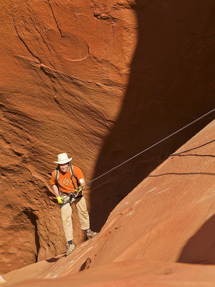 Adventurer Exploring A Desert Slot Canyon, San Rafael Swell, Utah, United States Of America